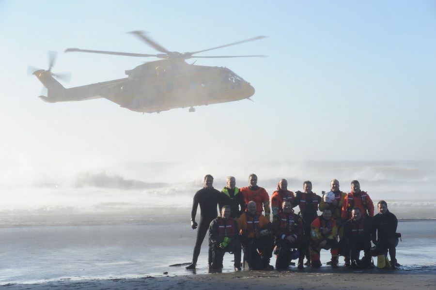 120127-G-LS819-001-AHRS-s U.S. Coast Guard Advanced Helicopter Rescue School (AHRS) students pose for a class photo on Waikiki Beach near Cape Disappointment, Wash