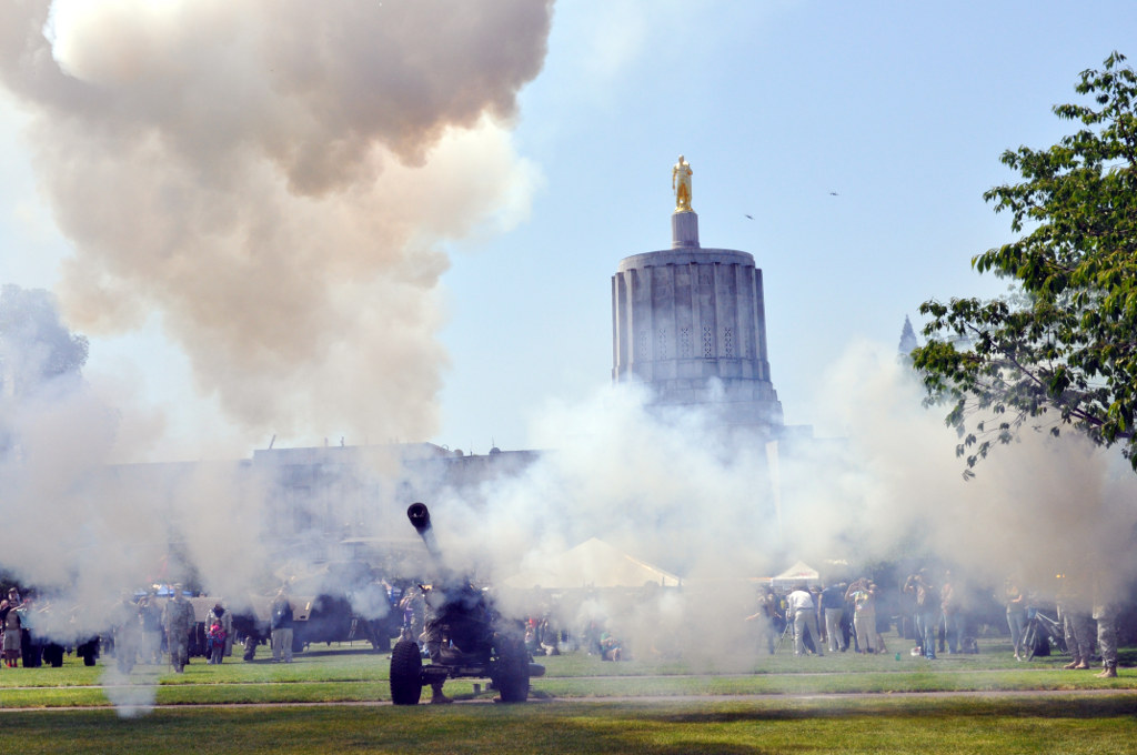 Howitzers from the Oregon Army National Guard's 2-218 Field Artillery Battalion fire a salute as two F-15 Eagles from the Oregon Air National Guard's 142nd Fighter Wing fade into the distant skies following a fly over at the State Capitol Mall Howitzers from the Oregon Army National Guard's 2-218 Field Artillery Battalion fire a salute as two F-15 Eagles from the Oregon Air National Guard's 142nd Fighter Wing fade into the distant skies following a fly over at the State Capitol Mall in honor of Armed Forces Day, May 17, in Salem, Ore. (Photo by Staff Sgt. April Davis, Oregon Military Department Public Affairs Office)