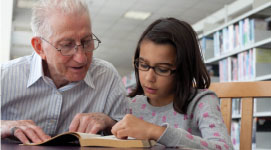 Grandfather reading to a child