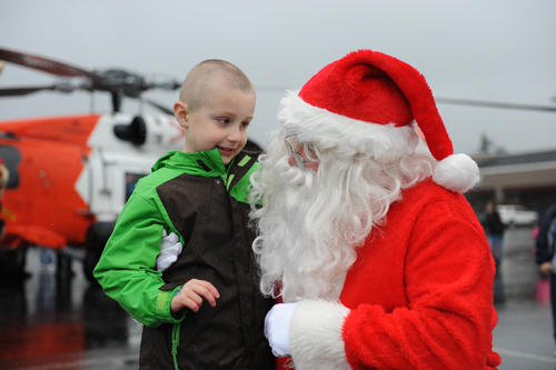 Braydan White (left), 5-year-old Seaside, Ore., community member and avid Christmas fan, visits with Santa in the Seaside Outlet Mall parking lot, November 17, 2012. A Coast Guard MH-60 Jayhawk helicopter crew from Sector Columbia River's Air Station Astoria transported Santa to the mall to help spread the word about a Toys for Tots campaign being held this holiday season along Oregon's North Coast and Southwestern Washington state. U.S. Coast Guard photo by Petty Officer 3rd Class Nate Littlejohn