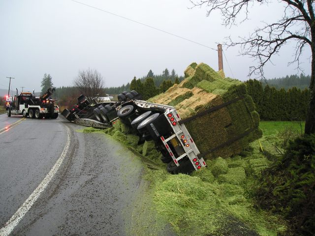 Crash scene 2005 Freightliner truck pulling two trailers loaded with hay