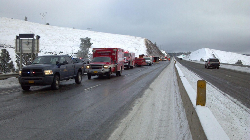 A photograph taken from the roadway showing emergency responding personnel at scene