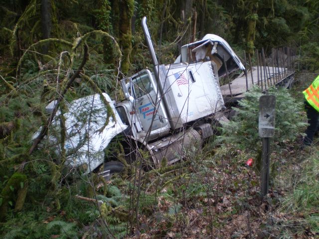 A commercial truck driver was seriously injured Monday afternoon when his truck pulling two semi-trailers traveled off Highway 58 about two miles west of Oakridge -2