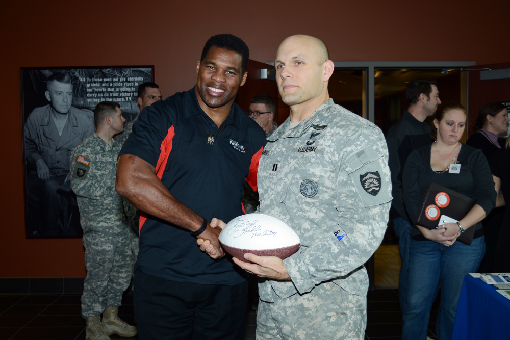 Herschel Walker, Heisman trophy winner and former NFL player, shakes hands with Oregon Army National Guard Captain Vincent Habeck at the 41 Infantry Division Armed Forces Reserve Center at Camp Withycombe in Clackamas, Ore., Feb. 6. Walker spoke to service members, veterans, and their families about his personal experiences with mental illness and the importance of seeking treatment. (Photo by Staff Sgt. April Davis, Oregon Military Department Public Affairs)
